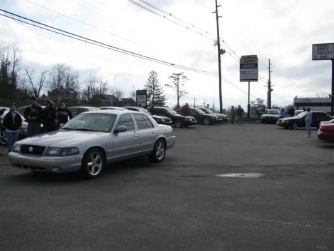 2003 Mercury Marauder - A group of people gather around a silver 2003 Mercury Marauder at an outdoor car meet.