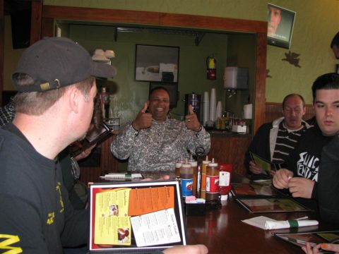 2003 Mercury Marauder - A group of people are gathered around a table at a restaurant, with menus and condiments visible.