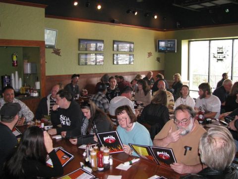 2003 Mercury Marauder - Diners are seated at tables in a restaurant, some reviewing menus.