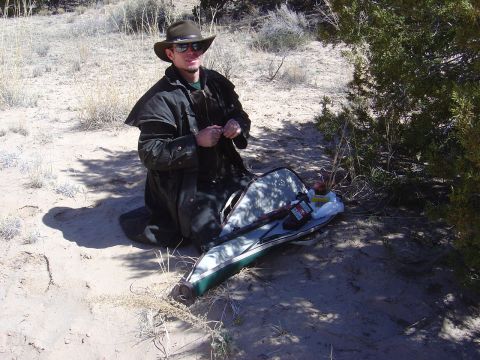 1986 Ford Bronco II - Man in desert with gun case and rifle.