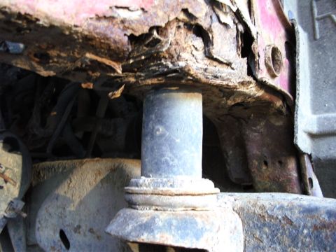 1994 Ford F-250 - Extensive rust damage is visible on the frame and suspension components of this vehicle.