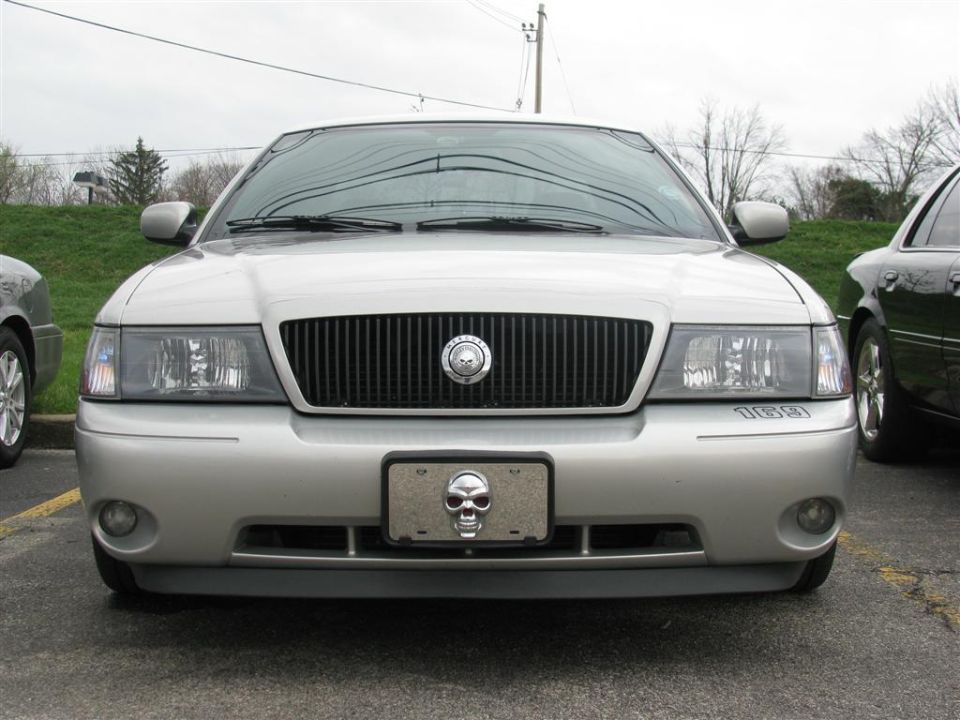 Silver sedan with vertical grille, skull license plate frame, and '10391' text on bumper