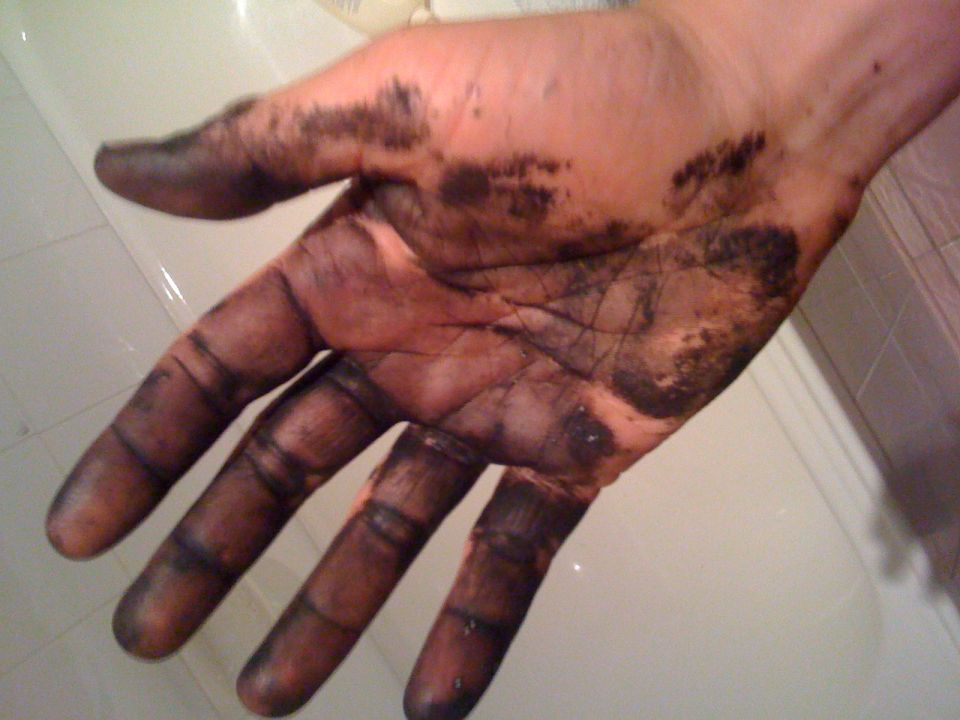 Dirty hand with grease on fingers and palm. Supermotors.net logo visible