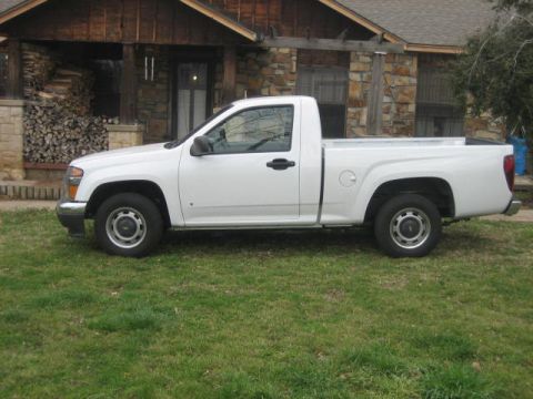 1996 Ford Thunderbird - A white pickup truck is parked on a grassy lawn in front of a house.