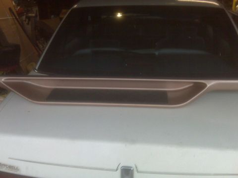 1995 Ford Bronco - The rear of a car is shown with a spoiler and a website address at the bottom.