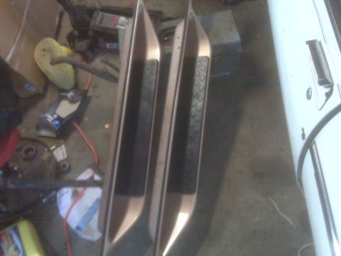 1995 Ford Bronco - Running boards for a vehicle are shown in a garage setting.