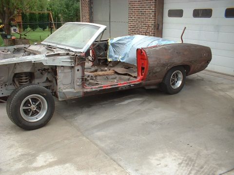 1970 Ford Torino - This convertible is in rough shape, showing significant rust and missing many parts during its restoration process.