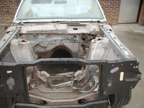 1970 Ford Torino - The engine bay of a 1970 Ford Torino is shown from the front, revealing its disassembled state.