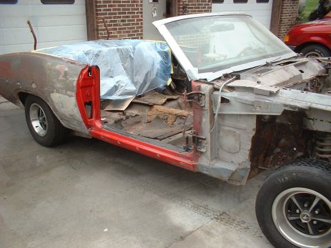 1970 Ford Torino - This classic car is in a state of disrepair, with its interior exposed and body panels showing significant rust.