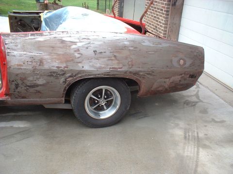 1970 Ford Torino - This 1970 Ford Torino is in the process of restoration, with its rear quarter panel stripped to bare metal and showing significant rust.