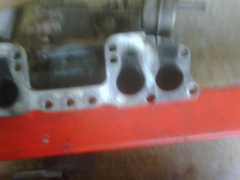 1986 Toyota Hilux - Close-up of an engine manifold, showing intake ports and mounting holes.