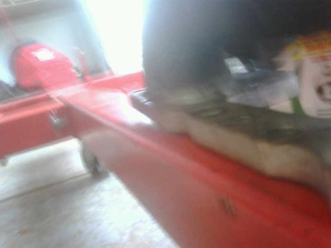 1986 Toyota Hilux - A red engine hoist is shown in a garage setting with a person's leg visible.