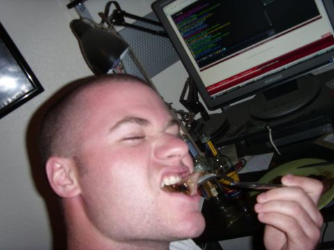 1978 Ford Bronco - A man is shown eating food from a fork while sitting in front of a computer displaying code.