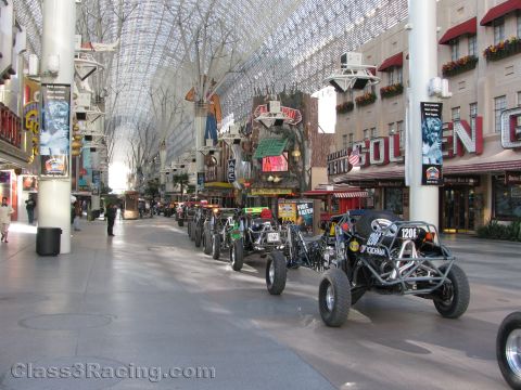 1990 Ford Bronco - row of off-road race buggies is lined up beneath the barrel-vaulted Fremont Street Experience canopy near the Golden Gate.