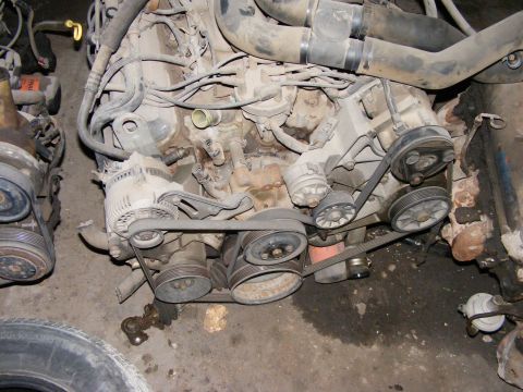 1979 Ford Bronco - Close-up view of a vehicle engine, showing belts, pulleys, and other components.