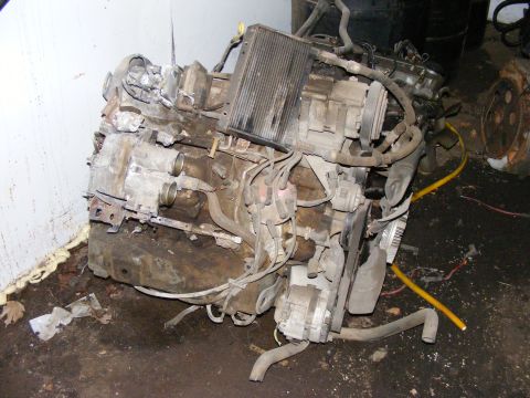 1979 Ford Bronco - Engine assembly with radiator and accessories, viewed from the front-right, resting on the floor.
