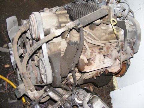 1979 Ford Bronco - Engine assembly with various components, including belts and pulleys.