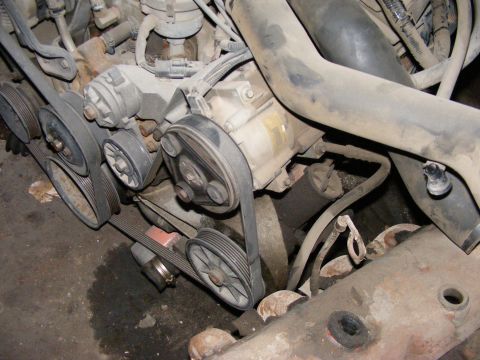 1979 Ford Bronco - Close-up view of an engine bay, focusing on the serpentine belt system and associated components.