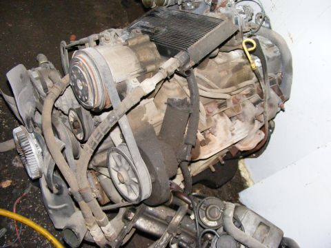 1979 Ford Bronco - Engine assembly with belts, pulleys, and air conditioning compressor visible.
