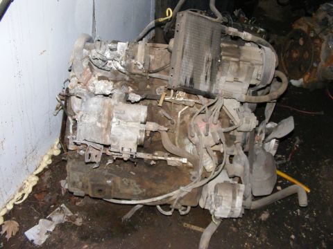 1979 Ford Bronco - Engine assembly with radiator and fan, appears dirty and used.