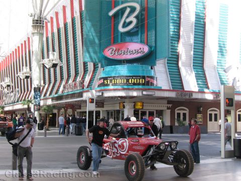 1990 Ford Bronco - red off-road race buggy stands beneath the Binion's casino marquee on Fremont Street in Las Vegas.