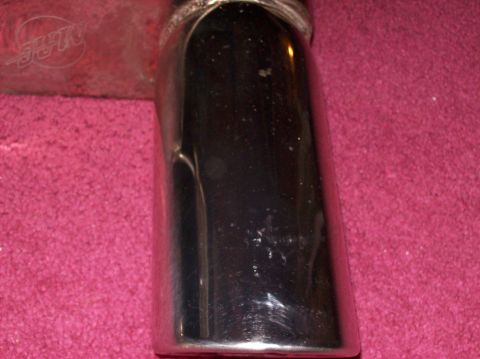 2007 Ford Mustang - Close-up of a chrome exhaust tip, the MAC logo on the left side.