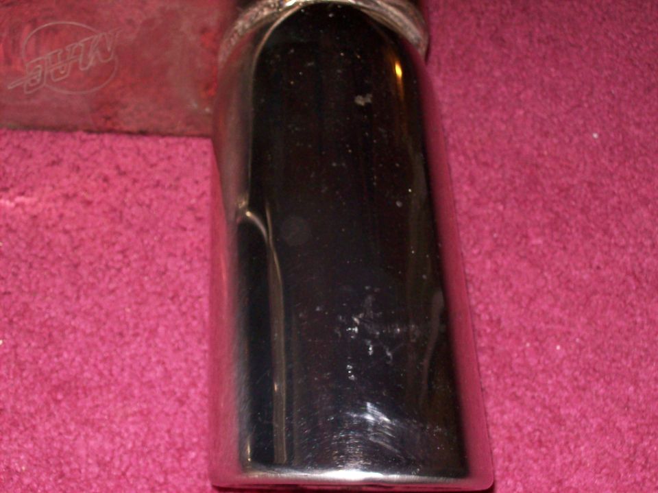 Chrome exhaust tip with MAC logo visible