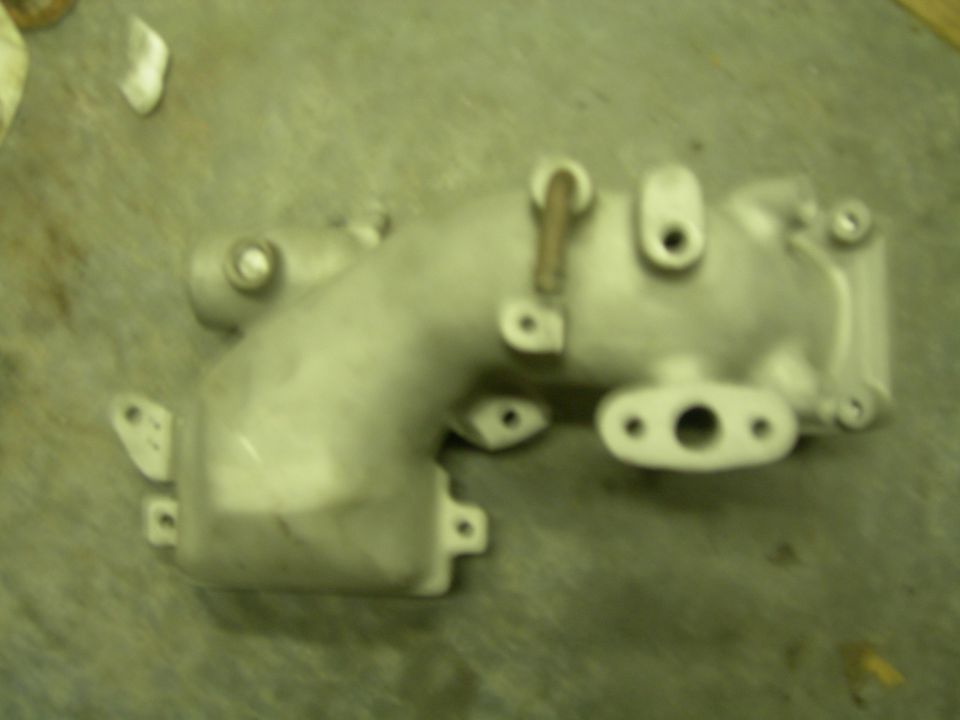 Aluminum intake manifold with two bolt holes and a central opening