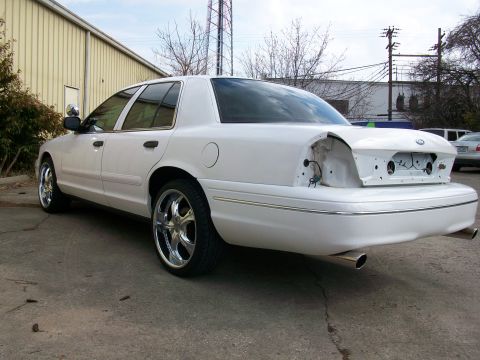 2003 Ford Crown Victoria - White 2003 Ford Crown Victoria with custom chrome wheels, rear bumper and taillights removed.