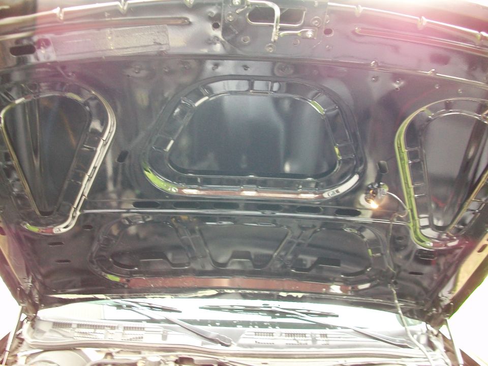 Underside of black hood with structural supports and insulation