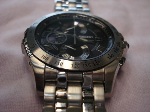 2000 Ford Crown Victoria - Close-up of a Seiko chronograph watch, showing its dial and metal band.
