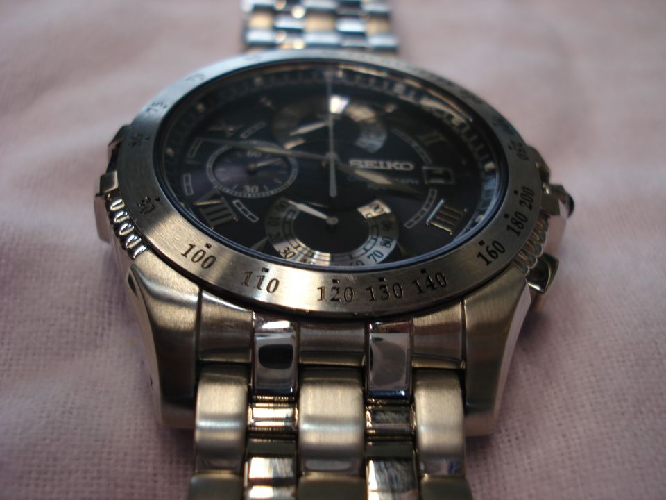 Seiko chronograph watch with black dial and tachymeter bezel