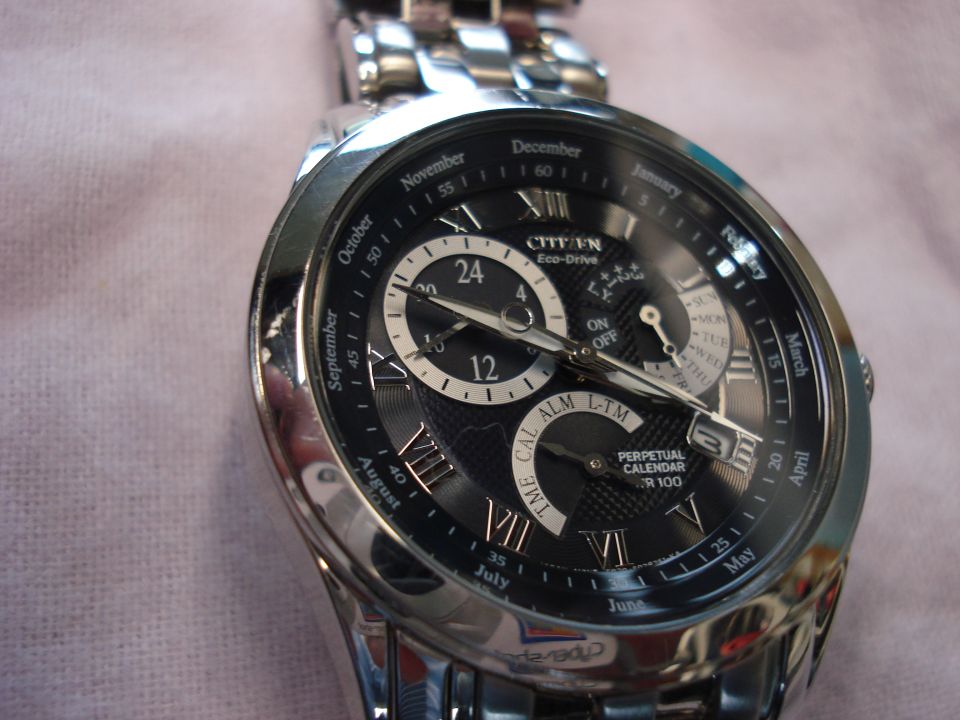 Close-up of a Citizen Eco-Drive Perpetual Calendar watch face with Roman numerals and multiple subdials
