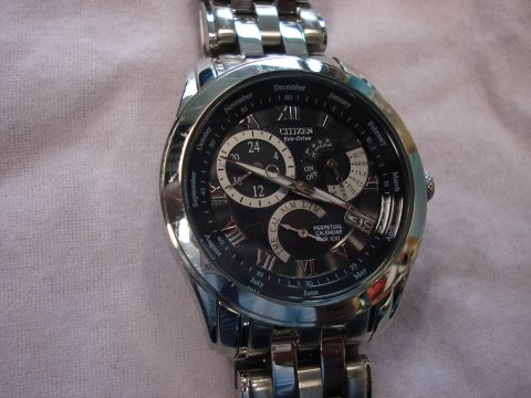 2000 Ford Crown Victoria - Close-up of a Citizen Eco-Drive Perpetual Calendar watch face and band.