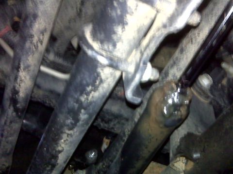 2008 Jeep Wrangler - Close-up view of a vehicle's steering stabilizer assembly, showing various metal components.