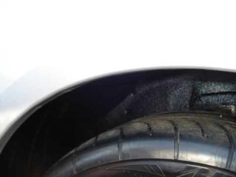 1998 Ford Taurus - A close-up view of the tire and inner fender well of a vehicle, with a Supermotors.net watermark visible.