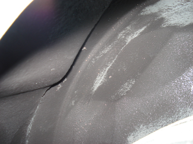 Cracked black wheel well liner
