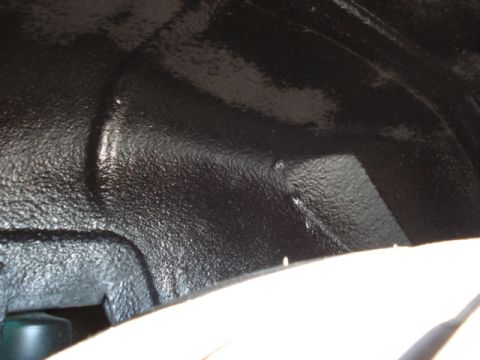 1998 Ford Taurus - The underside of a vehicle shows a textured black coating, likely for protection.