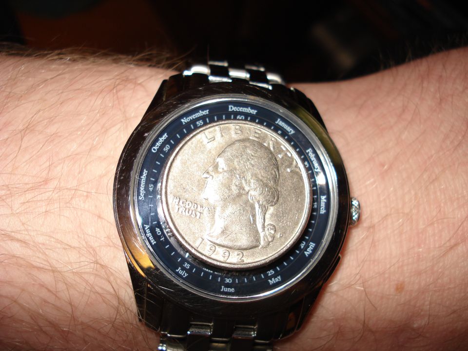 Watch face showing a 1992 quarter and month indicators