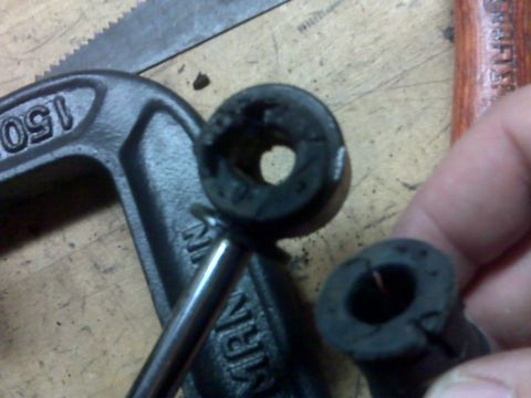 2008 Jeep Wrangler - Close-up of worn rubber bushings and a c-clamp, suggesting a repair or maintenance task.