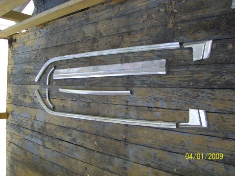 1972 Ford Ranchero - Several chrome trim pieces are displayed on weathered wooden planks, with a date stamp indicating April 1, 2009.