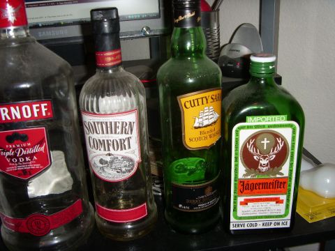 1978 Ford Bronco - Collection of liquor bottles including Smirnoff, Southern Comfort, Cutty Sark, and Jägermeister.