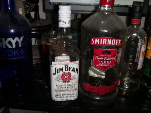 1978 Ford Bronco - A collection of empty alcohol bottles are displayed on a surface, with a computer monitor in the background.