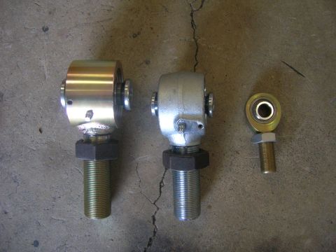 1996 Ford Bronco - Three metal rod ends, two large and one small, are displayed on a concrete floor.
