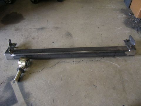 1996 Ford Bronco - A fabricated metal bar, likely for a vehicle's suspension, is shown with a bracket and heim joint attached.