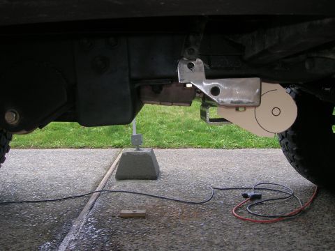 1996 Ford Bronco - A close-up view of a vehicle's suspension system, showing a metal bracket and a circular component.