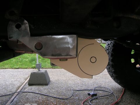1996 Ford Bronco - Close-up of a vehicle's rear suspension part, showing a metal bracket and a custom-made component.