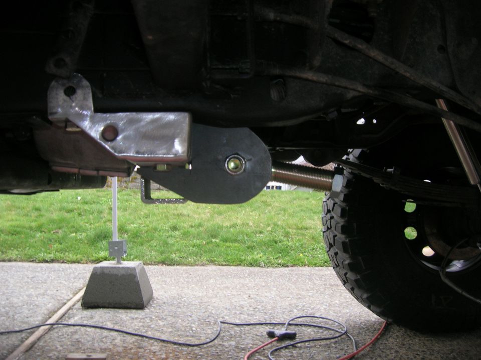 1996 Ford Bronco rear suspension part with a metal bracket and black rubber bushing