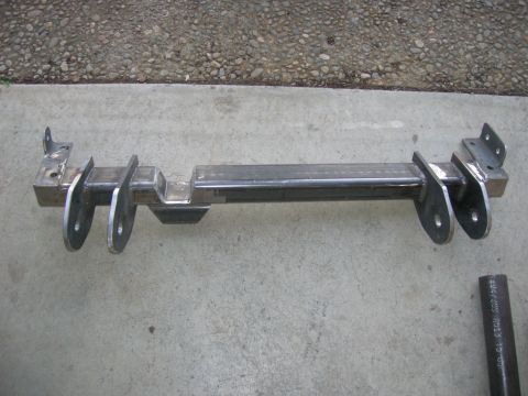 1996 Ford Bronco - A fabricated metal crossmember with suspension mounting points is shown on a concrete surface.