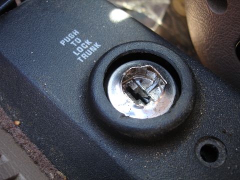 1995 Ford Taurus - The trunk lock mechanism shows signs of damage and wear.